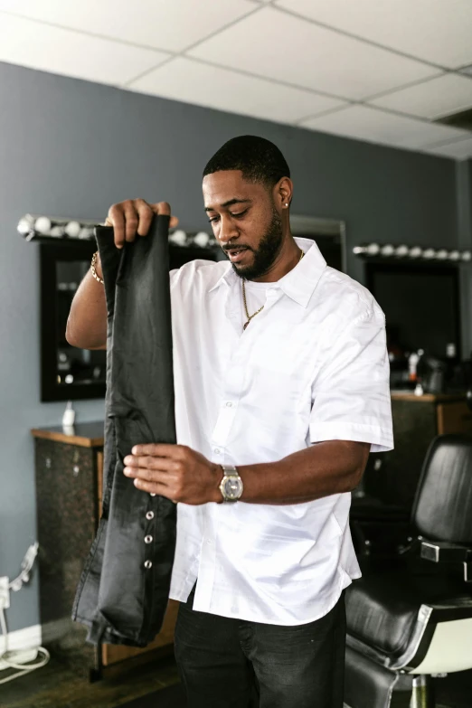 a man with tattoos is looking through his tie