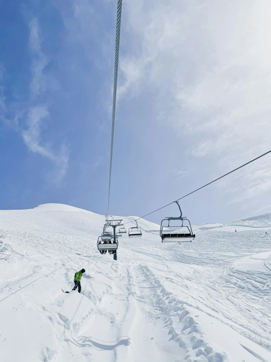 a couple of skiers skiing down the snow covered mountain