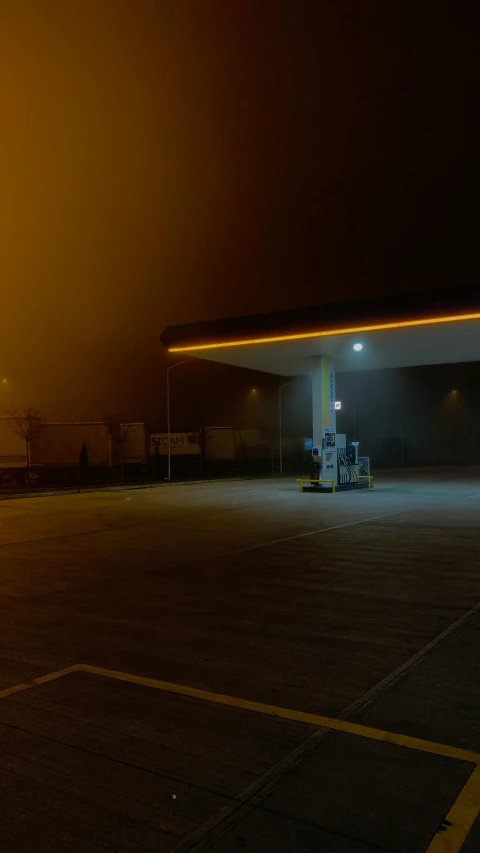 an empty parking lot with a gas pump