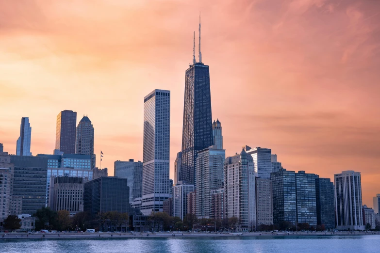 a city skyline with skyscrs with some sky in the background