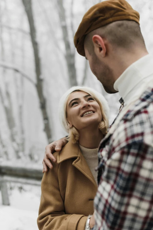 a woman emcing a man in the woods