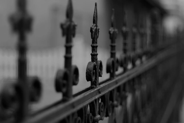 a fence that has metal posts and wrought iron