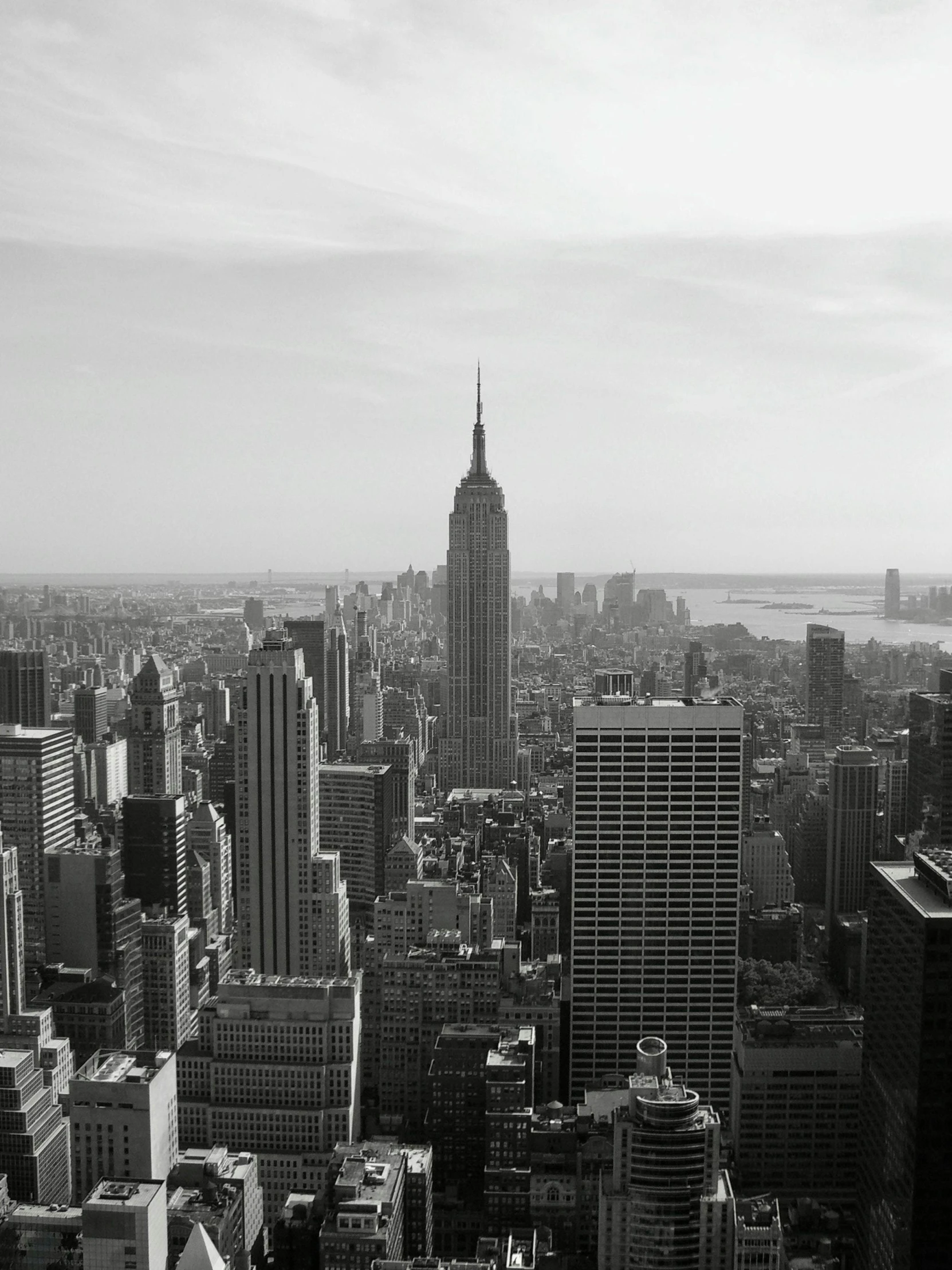 the cityscape is black and white, while it looks over looking a large body of water