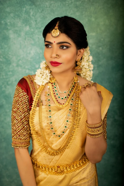 a young woman with a jewelry on her neck wearing gold jewellery