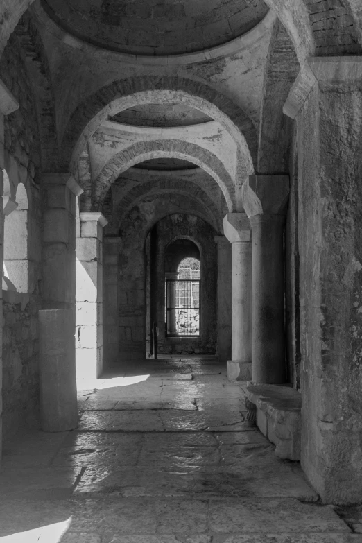 the inside of a very old building with a lot of arches