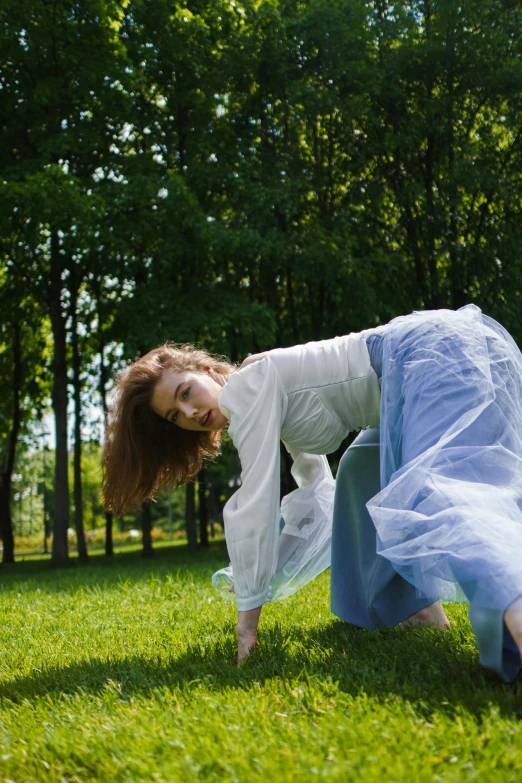 a woman in blue pants is doing some sort of dance