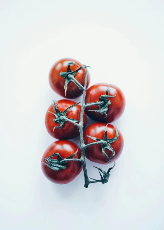 four tomatoes sitting on top of each other