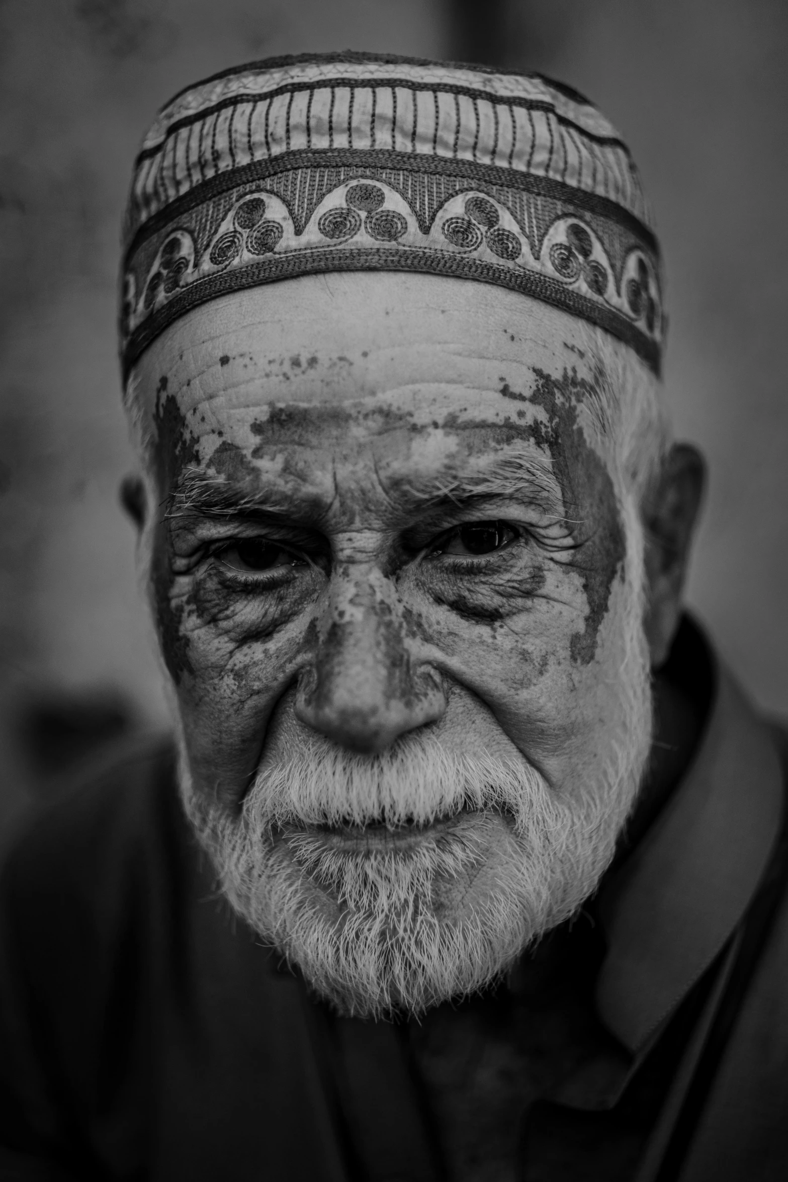 an elderly man with white and black paint on his face