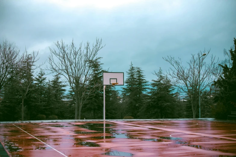 a basketball hoop with a basket on an empty court