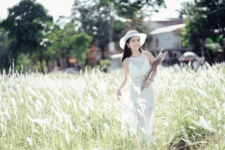 woman wearing hat and holding a bouquet of flowers