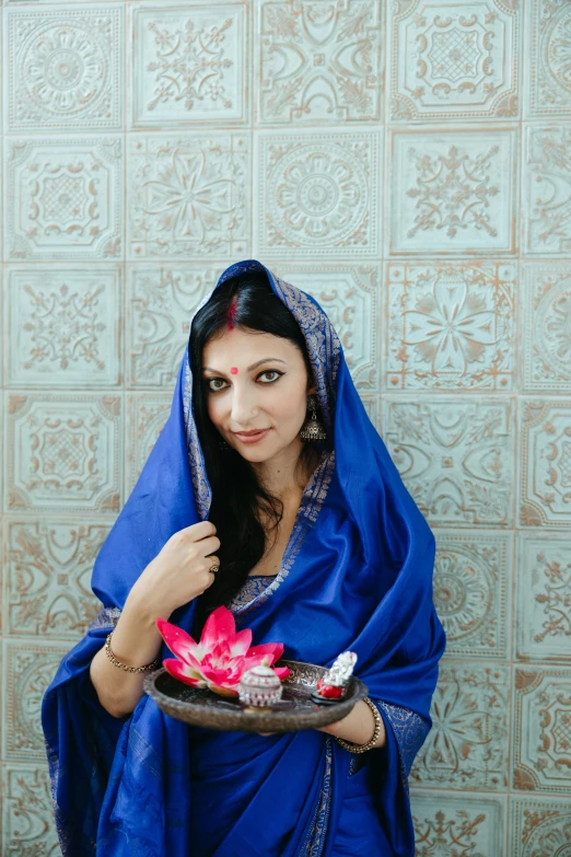 a woman holding a dish full of dessert