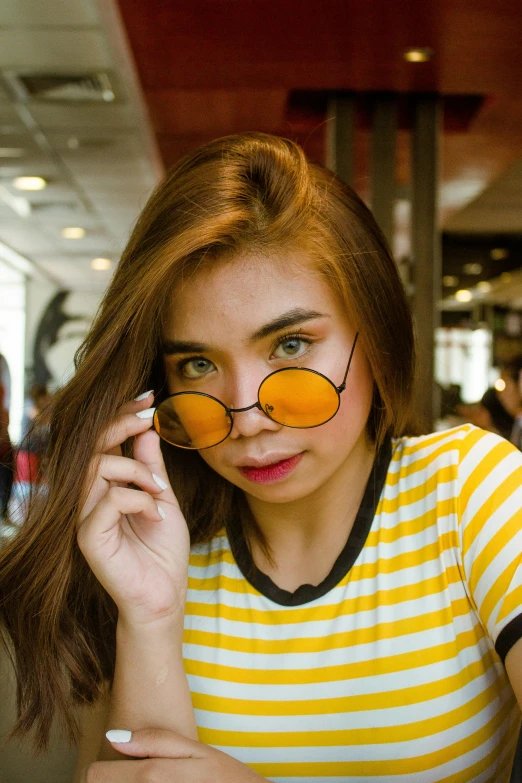 a woman with sunglasses looks at her phone