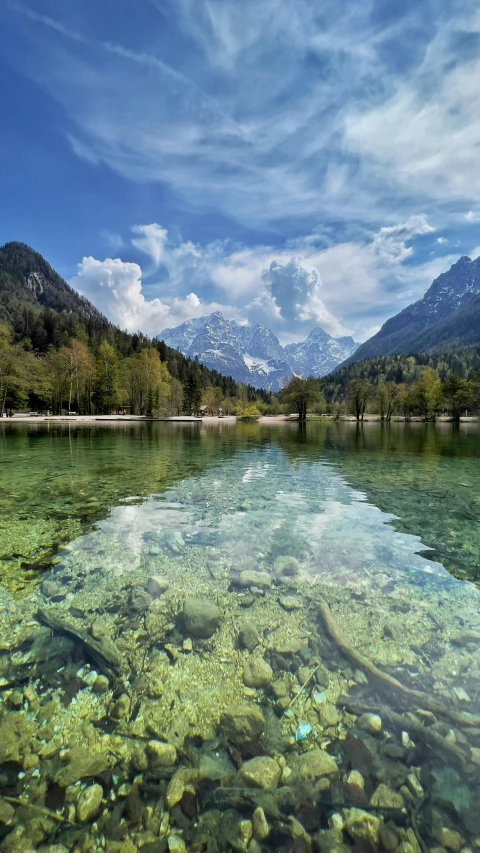 a mountain lake that has several small stones in it