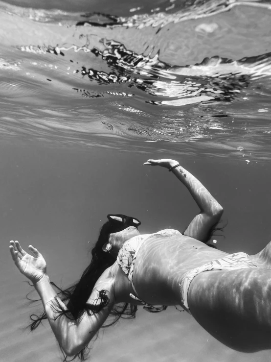 woman swimming off the beach wearing a bathing suit