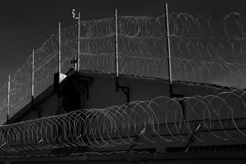 a black and white po of a building's fence that has the number 8 and stars coming out