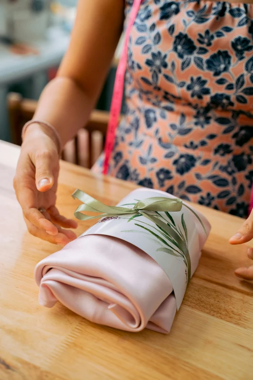 woman making fabric with bamboo sticks and cloth