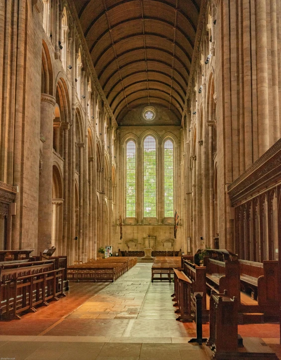 an ornate cathedral with multiple pews, benches and a bench