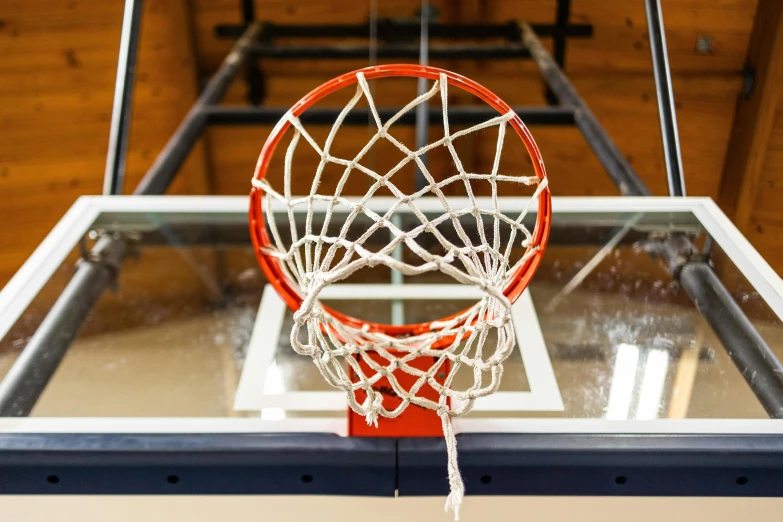 a basketball goal being taken out to see the basketball going in for an air