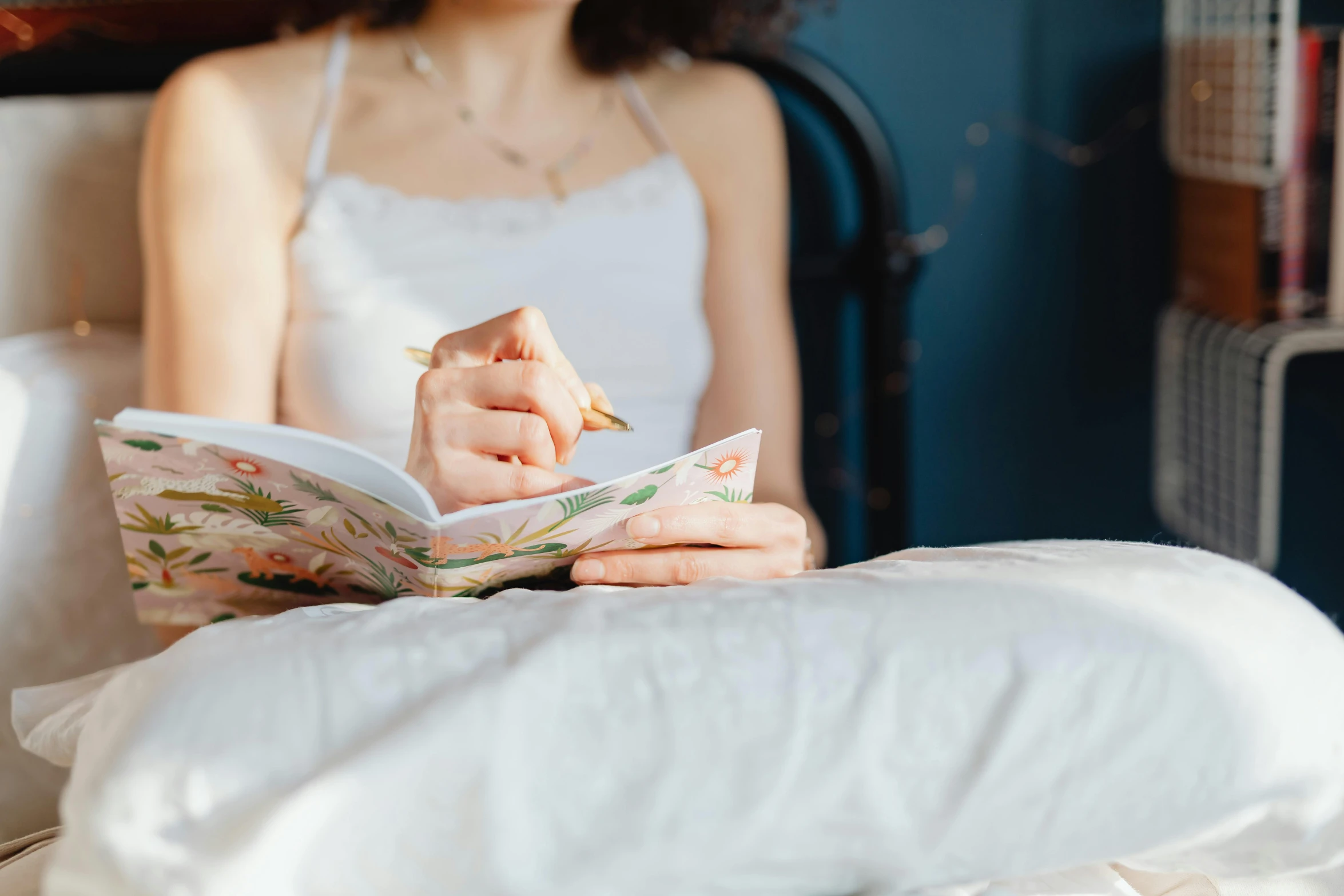 a young woman in bed reading a book