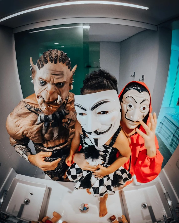 three people with masks in a bathroom