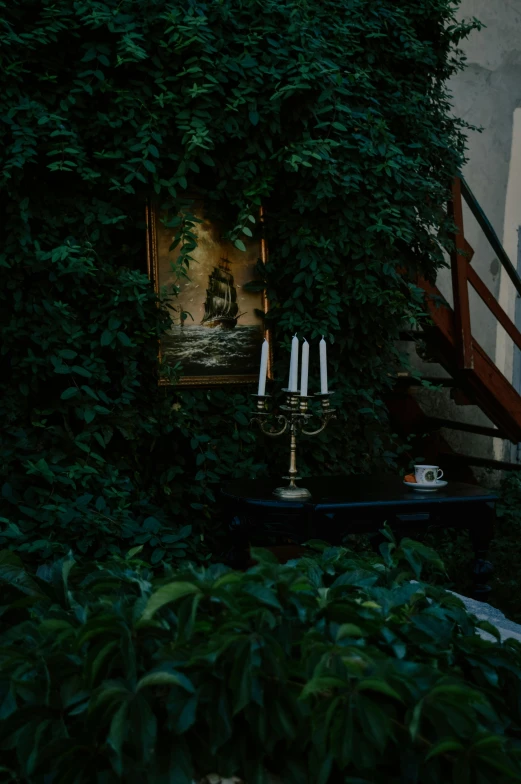 an urn with three candles on it sits in front of a building