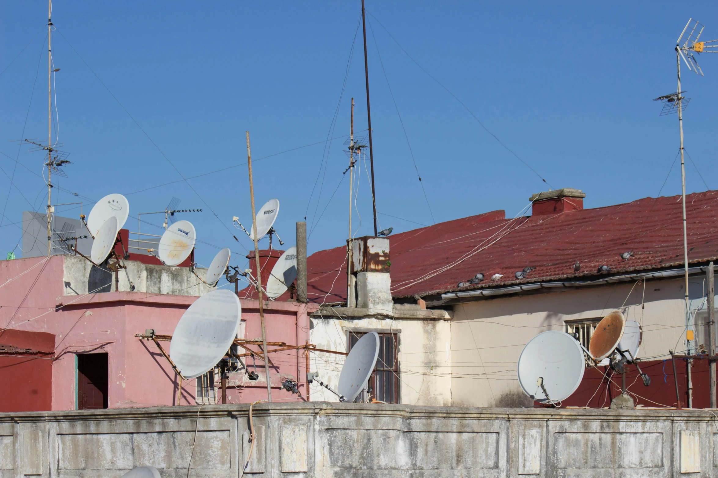 many antennas sitting on top of a building