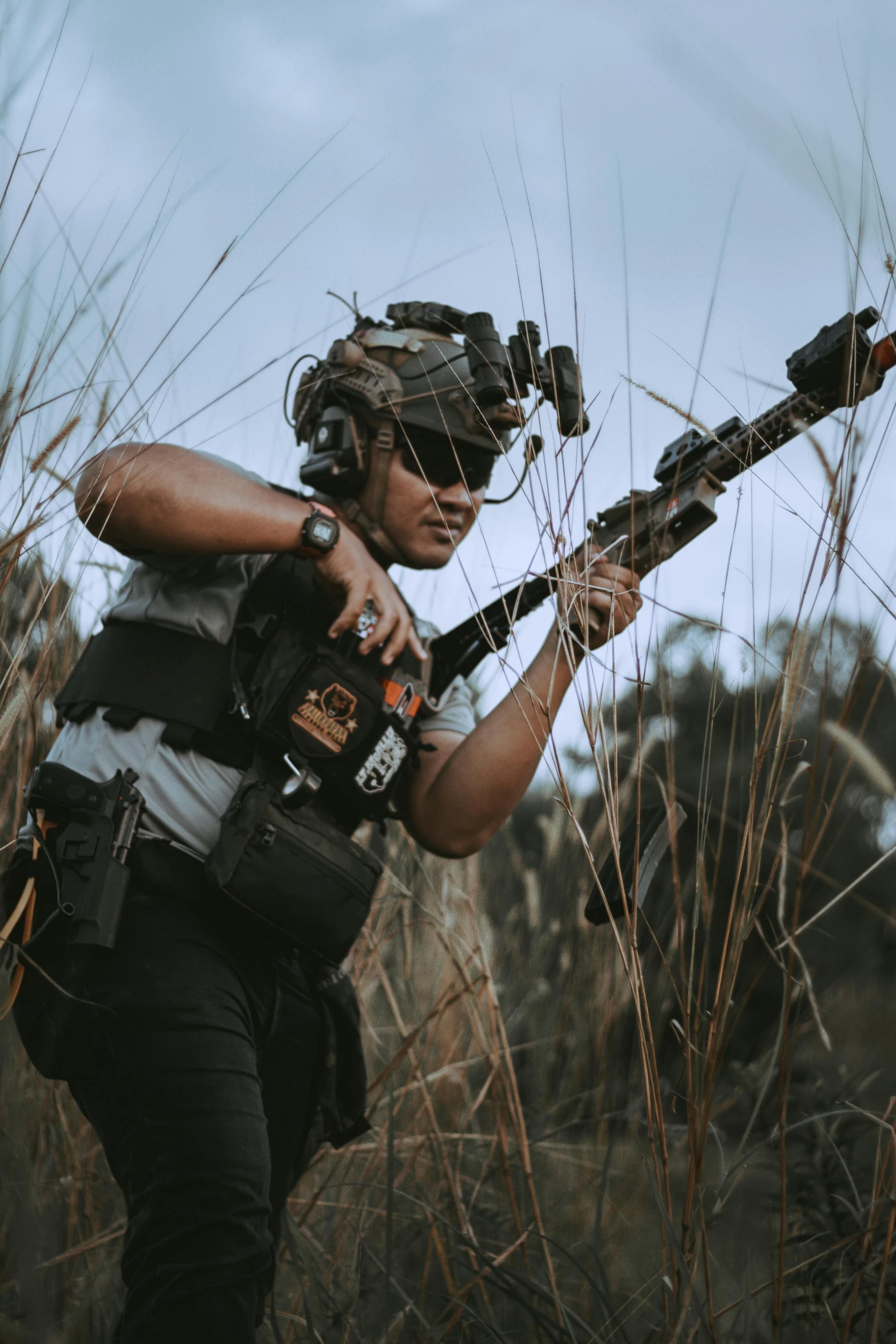 a young woman takes a break from shooting the weapon