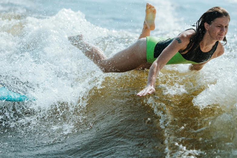 the woman is surfing on her board while she has no shoes