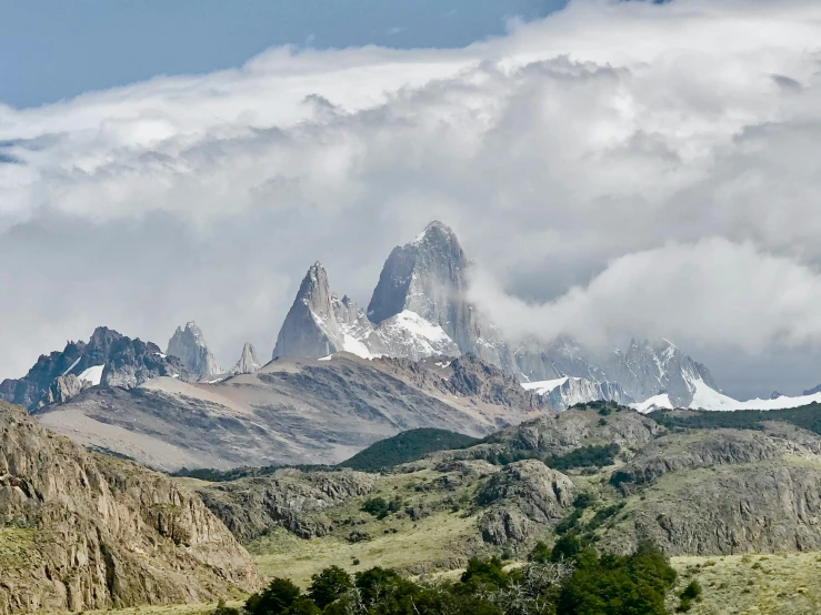 mountains in the distance surrounded by fog and clouds