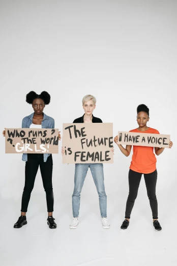 three people holding up signs with the same woman