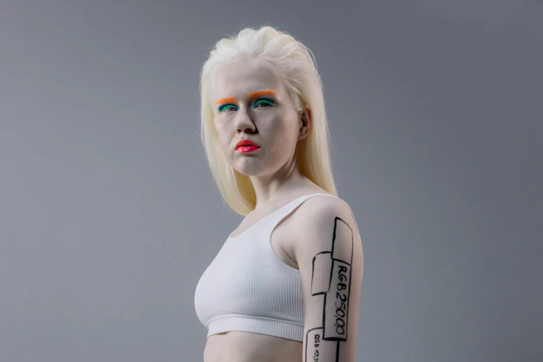 lady with white hair and neon makeup posing for the camera