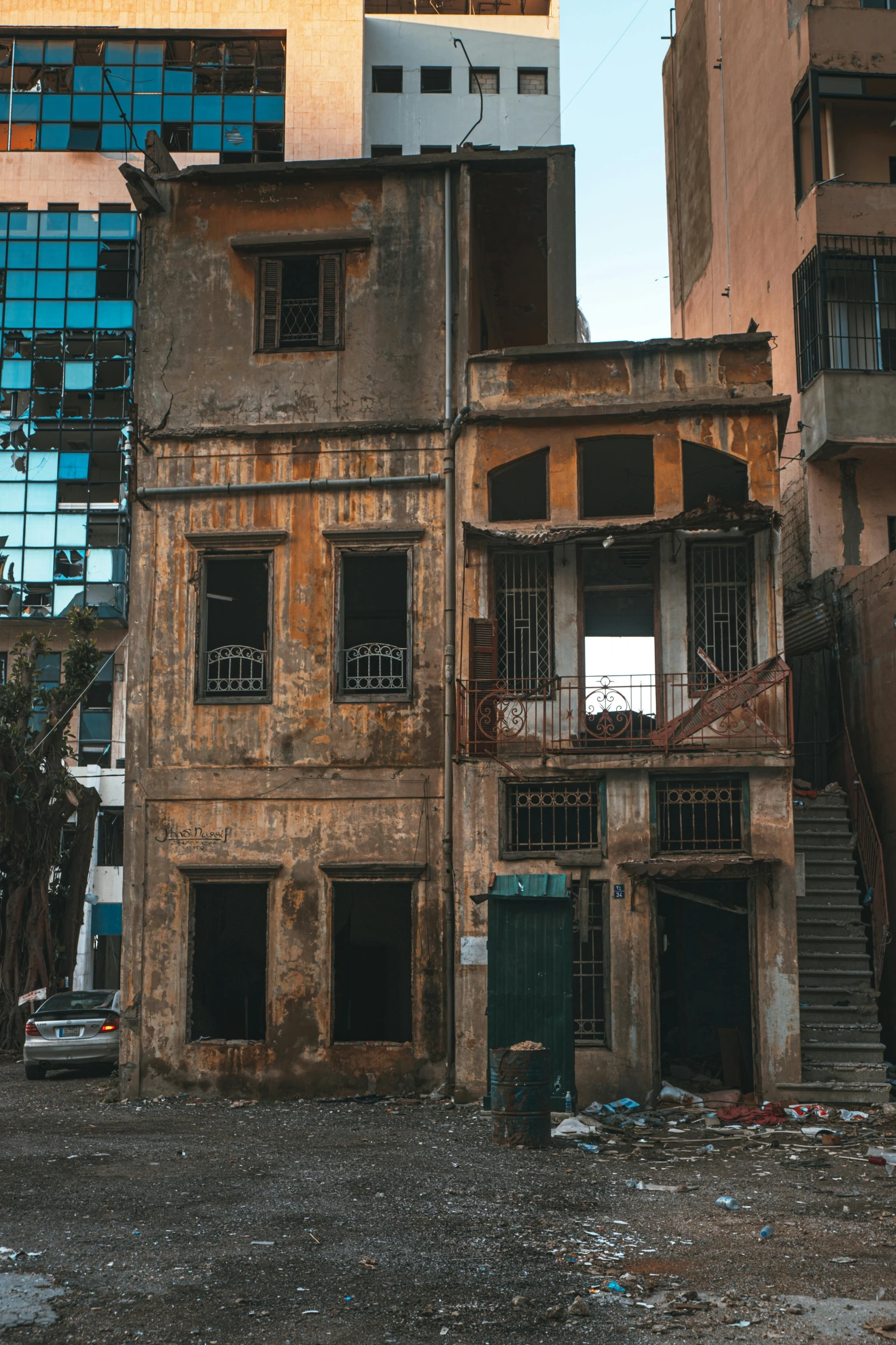 an old run down building has broken glass windows