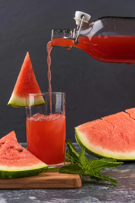 a person pouring water into a cup with watermelon slices