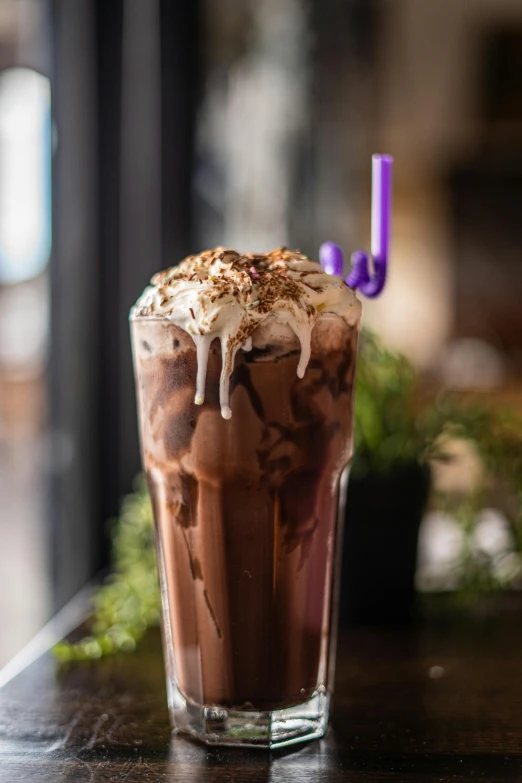 a chocolate iced drink sits on a table