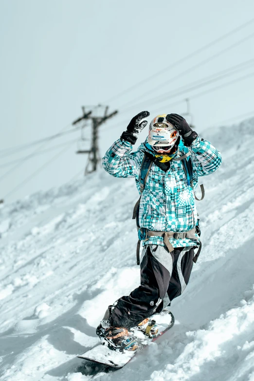 a young child snowboarding down a hill in winter gear