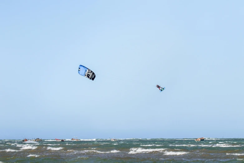 the people are kite boarding in the water