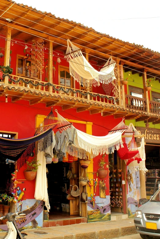 a colorful building has many banners and decorations in front of it