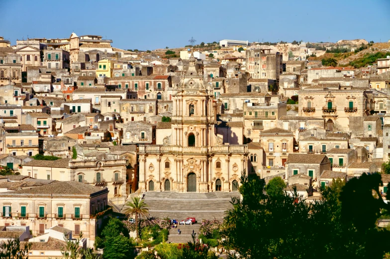 a town with towers and buildings surrounded by trees