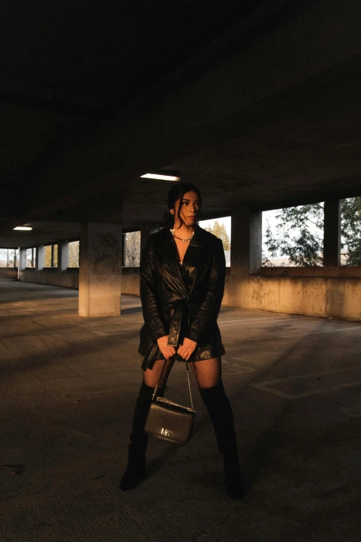 a woman standing in an empty parking lot