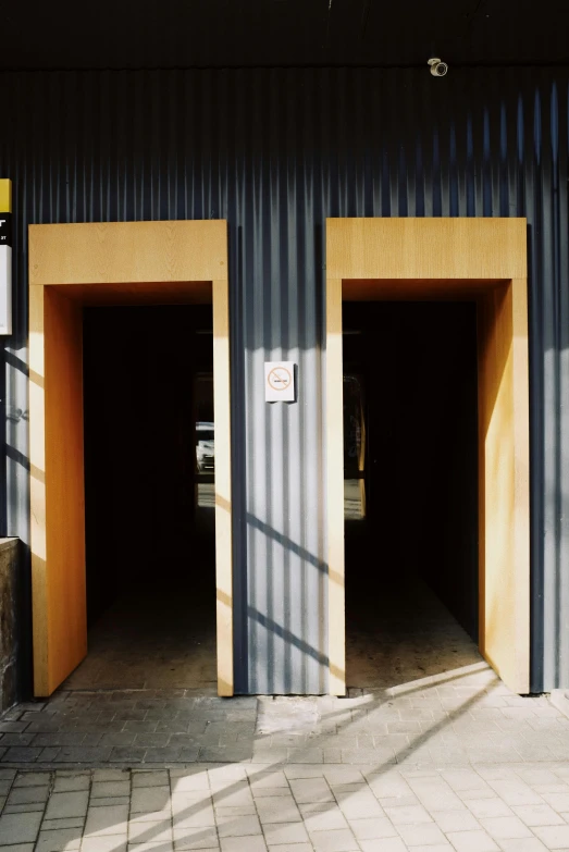 two wooden open doors in the side of a building