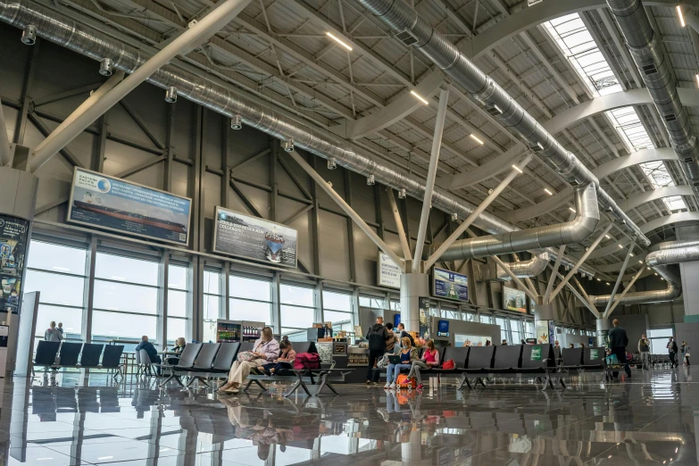 there are passengers at the airport waiting for their luggage