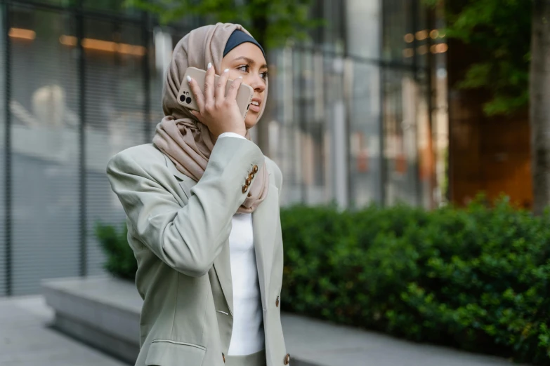 a woman is walking and talking on her cell phone