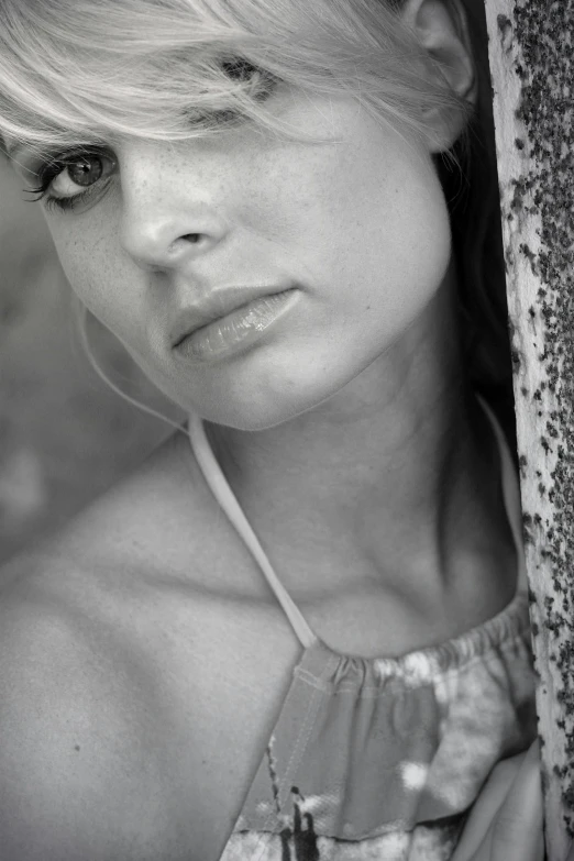 a girl with large black and white eyes posing for a pograph