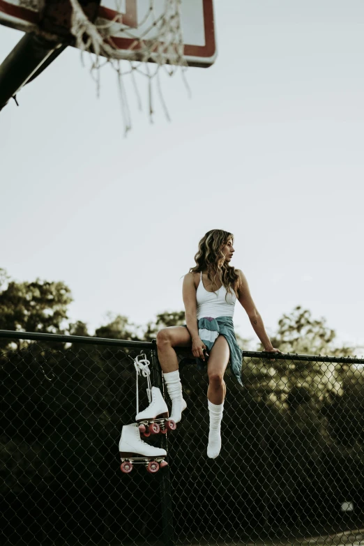  wearing a blue and white top sitting on the back of a fence