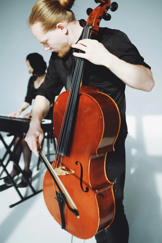 a man with a red hair playing the violin