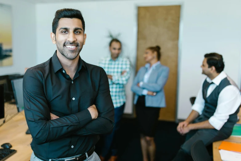 group of people in office standing with their arms crossed