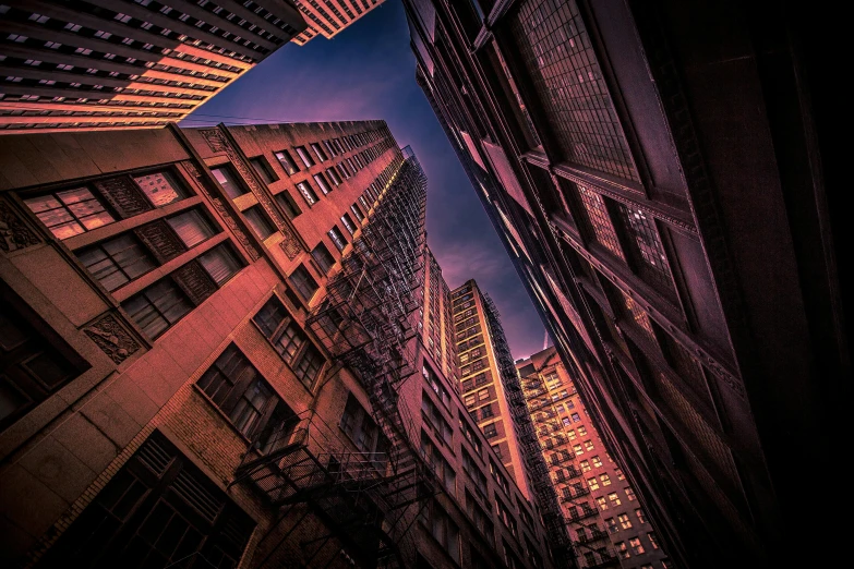 an empty street is seen through several tall buildings