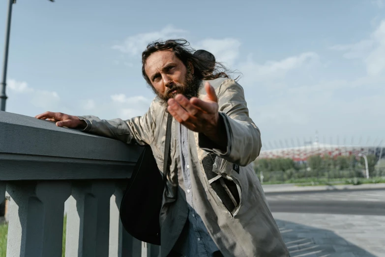 there is a man posing with his hands on the rail