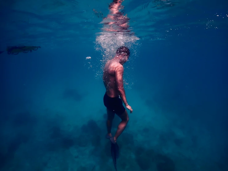 a person standing under water next to another person