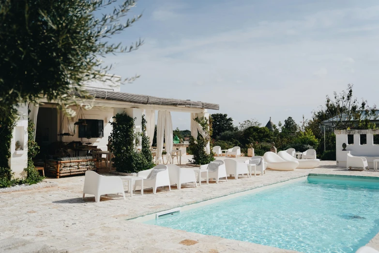 chairs sitting near an outdoor dining area by the swimming pool